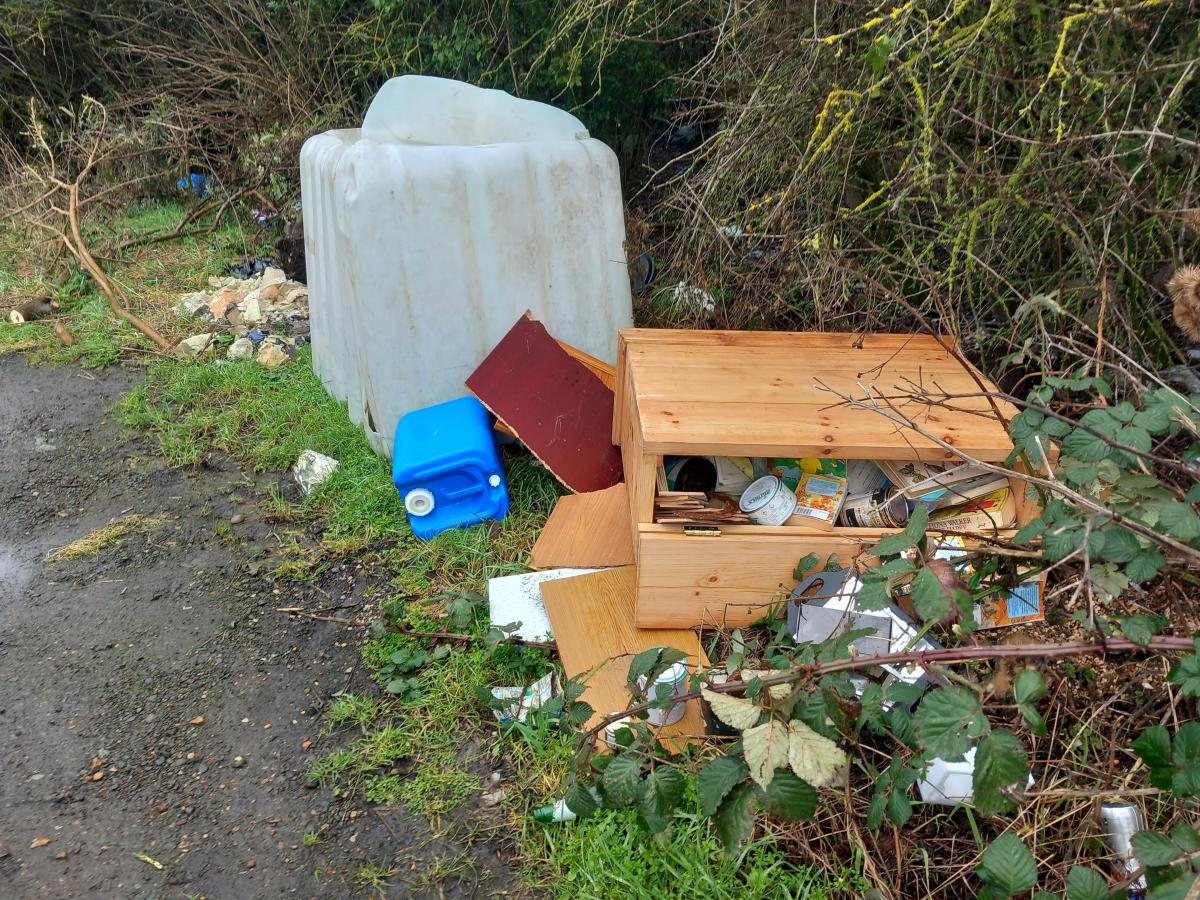 fly tipped waste on a grass verge