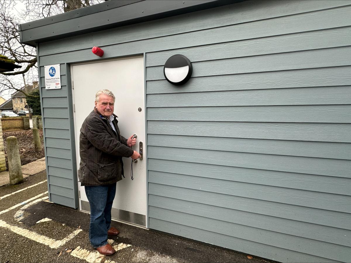 Cllr Bill Hunt standing outside the Changing Places toilet