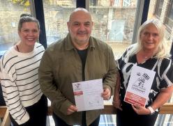 Housing team with employer recognition scheme documentation 