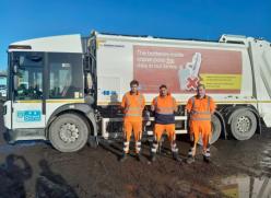 Waste lorry with crew members 