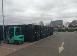 New black wheeled bins and food caddies being stored at the overflow car park at Littleport station 