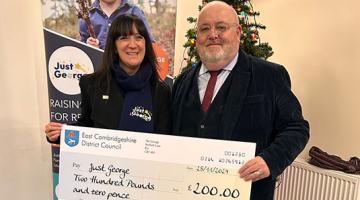 Cllr Goldsack and a member from the Just George charity holding a cheque