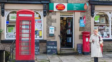 Lady standing outside post office door